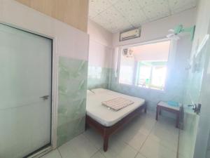 a small bathroom with a bed and a shower at Đào Huỳnh Motel in Nam Du +11 photos