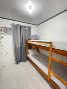 a room with two bunk beds and a fan at CJ cozy tiny home in Santa Barbara