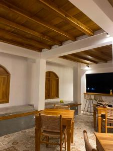 a living room with a table and some chairs at Tetebatu Sunset House in Tetebatu