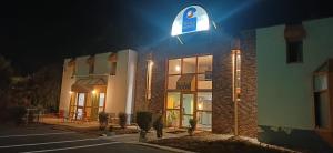 a building with a sign on the side of it at night at Class-Hôtel in Poitiers