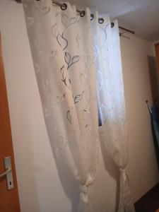 a white curtain with a tie on a wall at Gita in Omišalj +15 photos