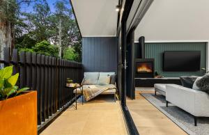a living room with a couch and a fireplace at The Sett in Sassafras