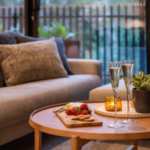 a table with two wine glasses and a tray of food at The Sett in Sassafras