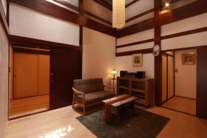 a living room with a chair and a table at 龍助25ANNEX Ryusuke25ANNEX in Komatsu