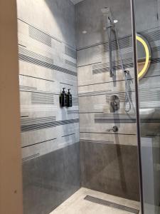 a shower with a glass door in a bathroom at M Convention Eluru in Elūru
