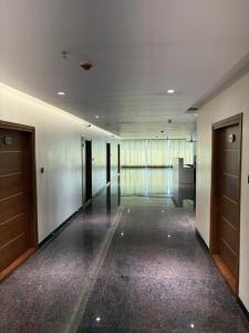 an empty hallway of a building with doors and floors at M Convention Eluru in Elūru