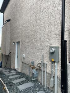 a brick building with some meters next to a wall at Lakeview 2Bedroom Walkout Suite with Trail View in Winnipeg +8 photos