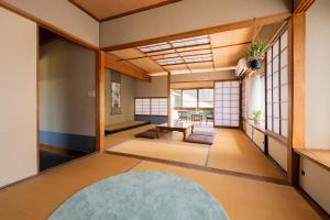 a japanese room with a table in the middle of the room at guesthouse LAPPY in Ureshino