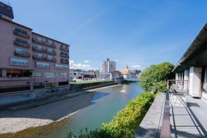 a view of a river in a city with buildings at guesthouse LAPPY in Ureshino