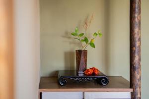 a table with a vase on it with a vase at guesthouse LAPPY in Ureshino +16 photos