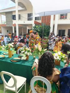 a group of people sitting at a table with flowers at Excel Roses Hotels in Kontrajeso