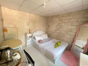 a small bedroom with a bed with bananas on it at Ao Klang Beach Resort in Ko Samed