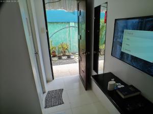 an open door to a room with a television at StayLite in Tagbilaran City