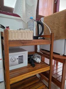 a shelf with a microwave and a bottle of water at Ao Klang Beach Resort in Ko Samed