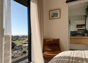 a bedroom with a view of a bed and a window at The Highland - Sunset Ridge in Ruatapu