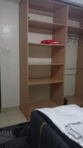 a bedroom with a book shelf next to a bed at Cess cozy stay maua in Maua