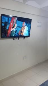 a flat screen tv hanging on a wall at Cess cozy stay maua in Maua