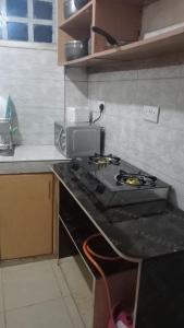 a kitchen with a stove and a counter top at Cess cozy stay maua in Maua