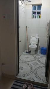 a bathroom with a toilet and a tile floor at Cess cozy stay maua in Maua