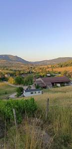 a farm with a building in the middle of a field at Ti caz prairie in Marnoz