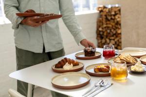a person holding a tray of food on a table at BlackBrick Gardens in Cape Town