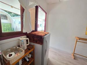 a small refrigerator in a room with a window at Ao Klang Beach Resort in Ko Samed +59 photos