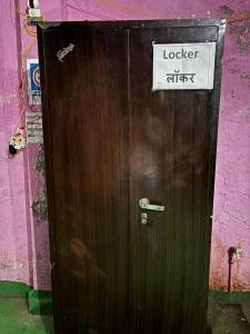 a wooden door with a sign on it at Brijwasi Seva Sadan in Mathura