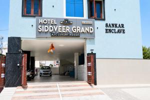 a hotel subleriver grand courtyard room with a car garage at Hotel Siddveer Grand in Guntūr