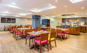 a restaurant with tables and chairs and a counter at Hotel Madrid Centro, Affiliated by Meliá in Madrid