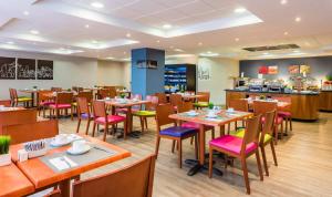 a restaurant with tables and chairs and a counter at Hotel Madrid Centro, Affiliated by Meliá in Madrid +19 photos