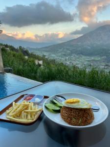 Ein Teller mit einem Sandwich und Pommes frites auf einem Tisch in der Unterkunft Pinggan Infinity - Private Pool Villa in Kintamani in Gretek