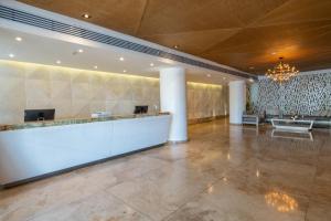 a lobby with a reception desk in a building at GHL Arsenal Hotel in Cartagena de Indias +64 photos