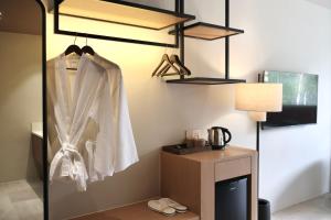 a room with a bed with a desk and a lamp at By The Hill in Bukit Mertajam