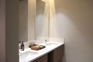 a bathroom with a white sink and a mirror at By The Hill in Bukit Mertajam
