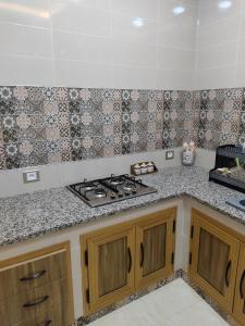 a kitchen with a stove and a counter top at شقق يوسف للكراء in Gabès