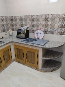 a kitchen with a sink and a counter top at شقق يوسف للكراء in Gabès +14 photos