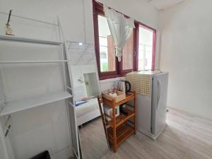 a kitchen with a refrigerator and a table in it at Ao Klang Beach Resort in Ko Samed