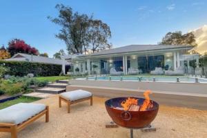 a fire pit in front of a house at Whitepepper Cottage in Pokolbin
