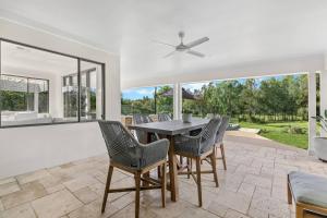 a dining room with a table and chairs at Whitepepper Cottage in Pokolbin