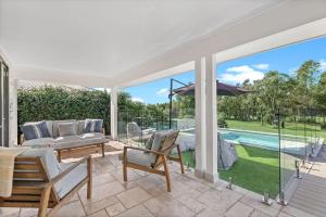 a house with a patio with a pool at Whitepepper Cottage in Pokolbin