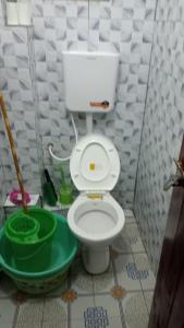 a bathroom with a white toilet and a sink at Cess cozy studio in Maua