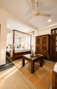a bedroom with a bed and a table in a room at Soulinn Regina Weligama in Weligama +78 photos