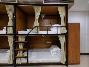 a room with three bunk beds in a room at Top of the Loop Hostel Ha Giang in Làng Me