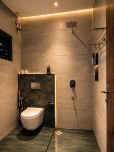 a bathroom with a toilet and a shower at Lofterra Luxury Apartment in Kozhikode city, calicut in Kozhikode +26 photos