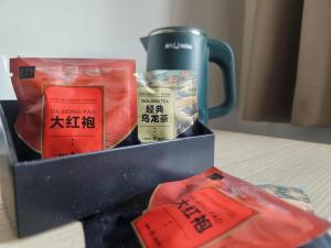 a box of food and a mug on a table at Man Va Hotel in Macau