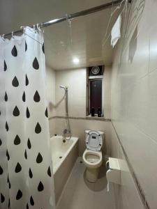 a bathroom with a toilet and a shower curtain at Man Va Hotel in Macau +223 photos