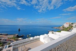 a view of the ocean from the balcony of a building at Meliá Madeira Mare in Funchal