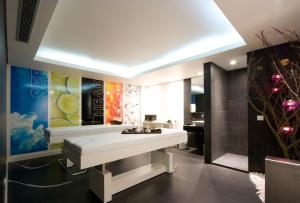 a bathroom with a white table and a sink at Meliá Madeira Mare in Funchal