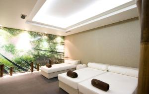 a living room with white couches and a large window at Meliá Madeira Mare in Funchal
