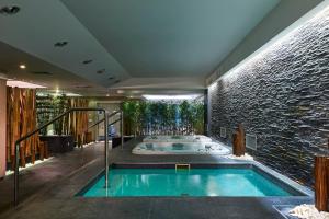 a hot tub in a room with a brick wall at Meliá Madeira Mare in Funchal +29 photos